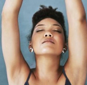 Woman doing yoga with her eyes closed