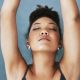 Woman doing yoga with her eyes closed