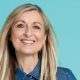 Fiona Phillips smiling at the camera on blue background