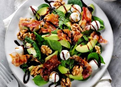 Walnut and pancetta salad in a white bowl