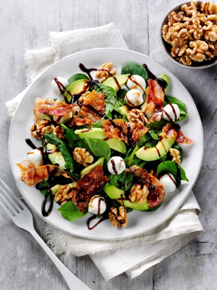 Walnut and pancetta salad in a white bowl