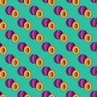 Purple plums on a flatlay green background