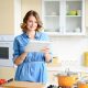 Woman in kitchen using tablet