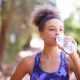 Woman drinking from a bottle of water in the park