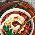 Vegan chilli con carne in a white bowl with wooden spoon