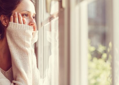 Woman looking out of the lonely wishing for a friend