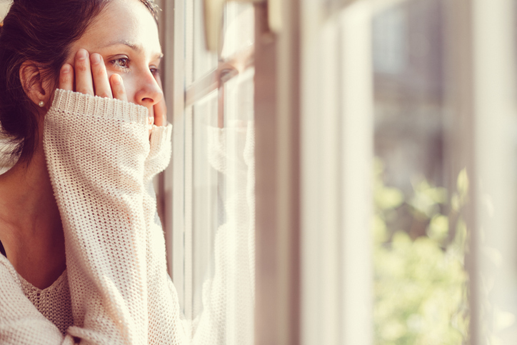 Woman looking out of the lonely wishing for a friend