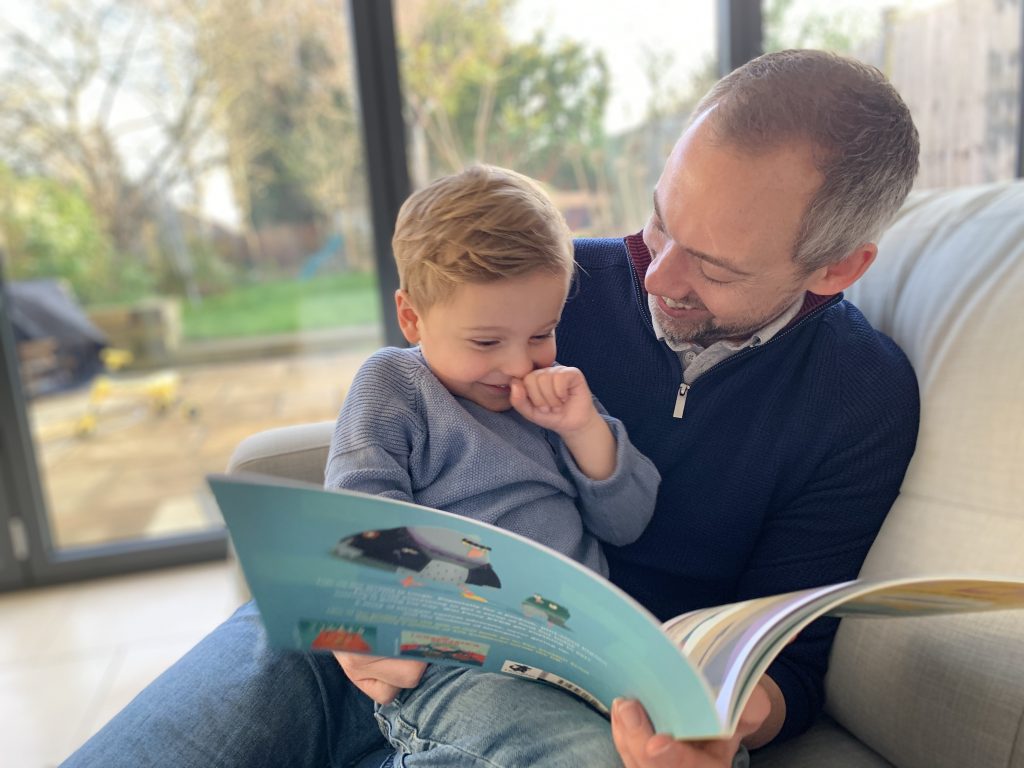 dad reading with young son on his lap