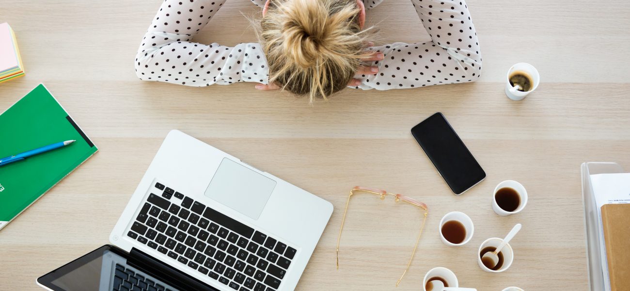 Young business woman napping at her desk to conquer Blue Monday