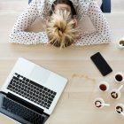 Young business woman napping at her desk to conquer Blue Monday