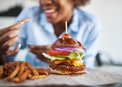 Woman getting ready to enjoy a burger and chips at the weekend