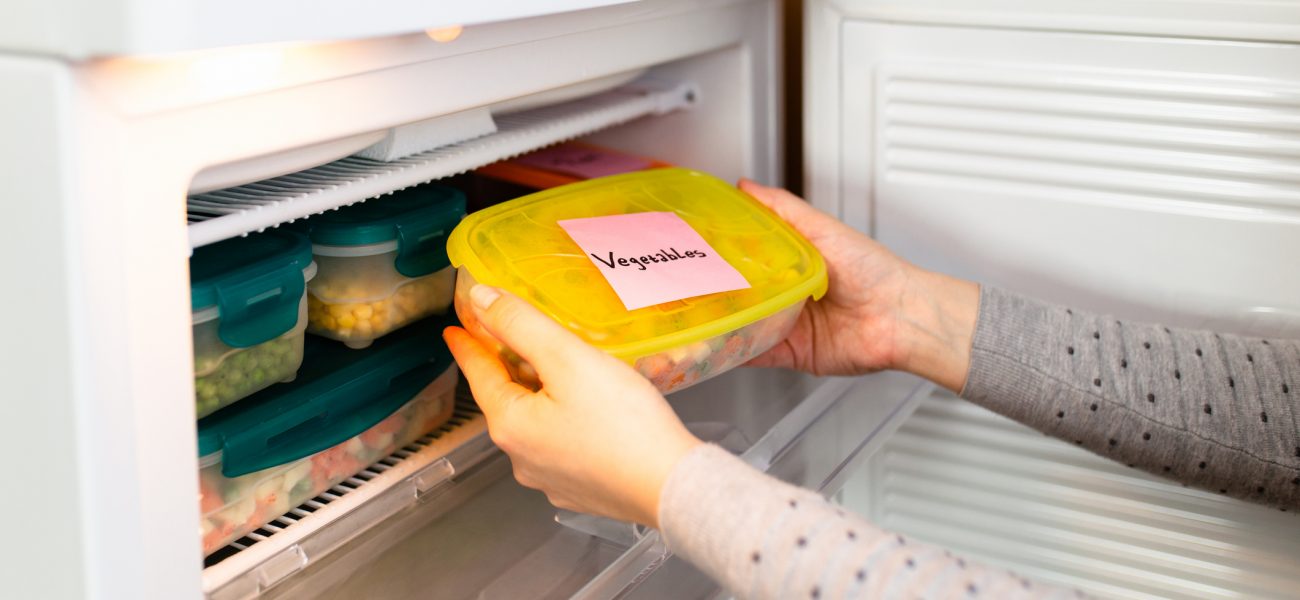 Woman labels her fruits and vegetables ready to be frozen during the coronavirus pandemic