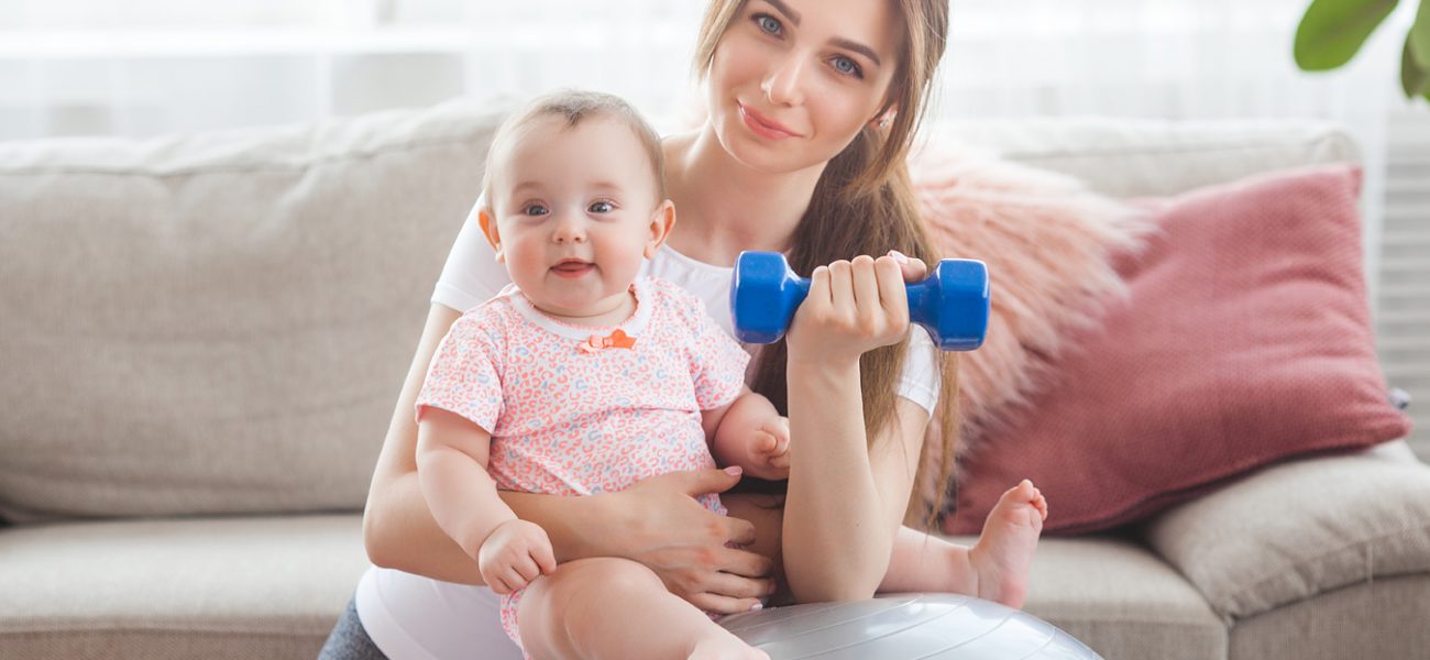 Mother with a baby, doing postnatal workout