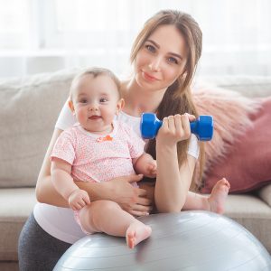Mother with a baby, doing postnatal workout