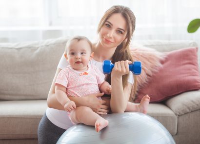 Mother with a baby, doing postnatal workout