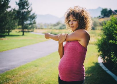 Pregnant woman warming up, ready to do a prenatal exercise run