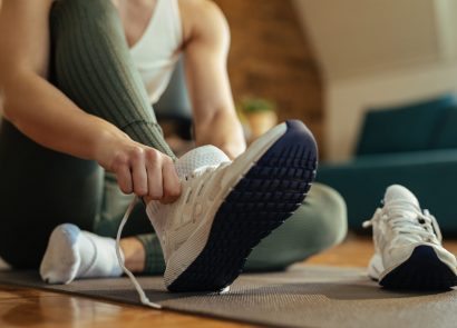 Woman putting on trainers for indoor workout