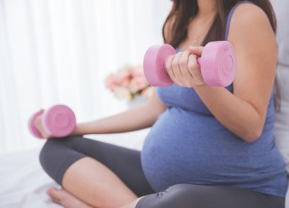 Woman enjoying some exercise with small weights while pregnant