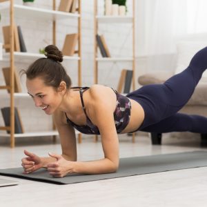 Woman working out while watching Davina McCall's fitness videos