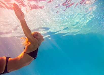 woman swimming under water