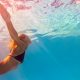 woman swimming under water