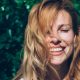 Woman smiling in the sunshine, enjoying vitamin D