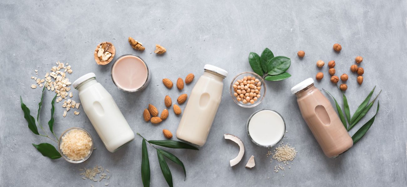 dairy-free milk bottles on grey background