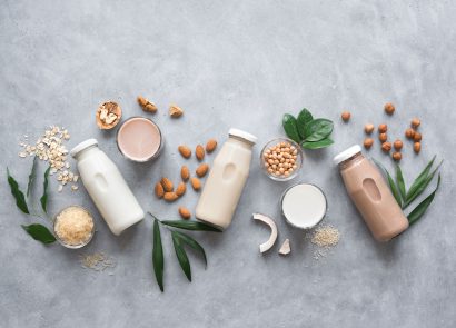 dairy-free milk bottles on grey background