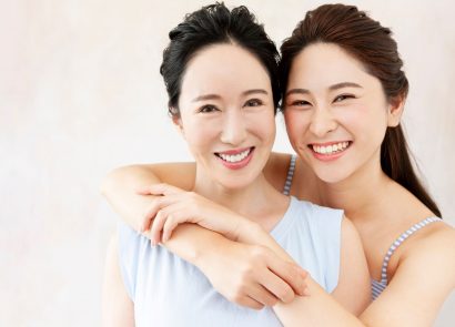 Mother and daughter with clear skin smiling