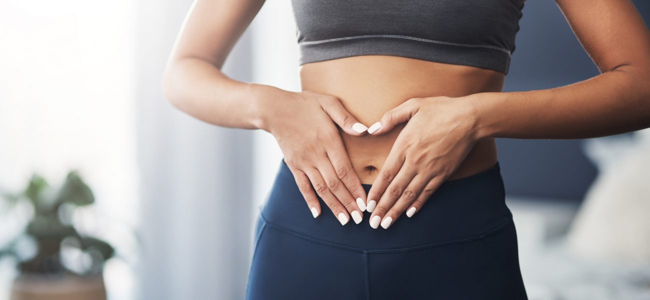 woman with hands on stomach