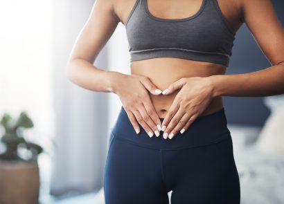 woman with hands on stomach