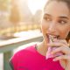 woman outside eating protein bar healthy snack