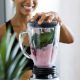 woman making a healthy smoothie in a blender