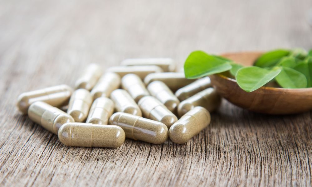 vitamin capsules on a wooden surface