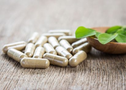 vitamin capsules on a wooden surface