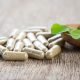 vitamin capsules on a wooden surface