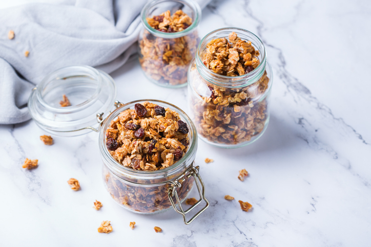 Homemade granola in glass jars on a marble surface