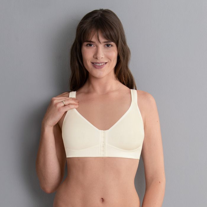 model on grey background wearing cream mastectomy bra