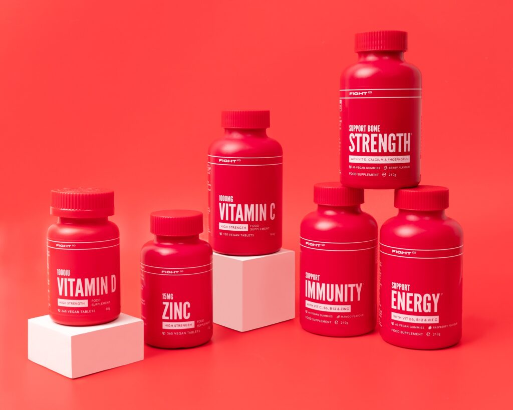 display of fight vitamin bottles on red background