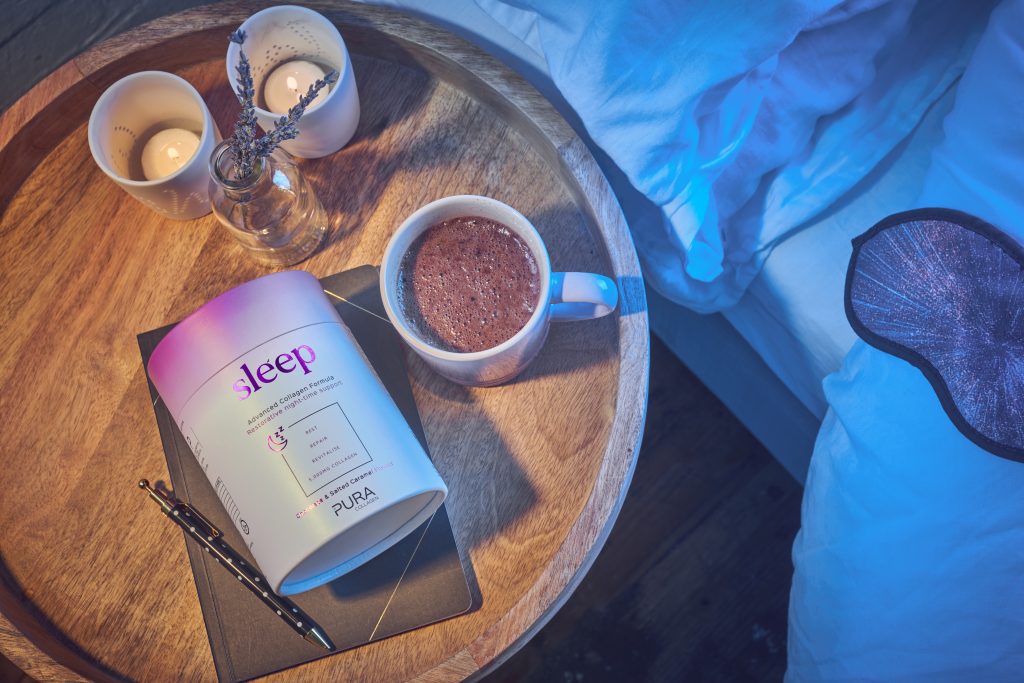 How to boost sleeping hormones – illustrated by a mug of Pura Sleep Advanced Collagen Formula on nightstand at bedtime.