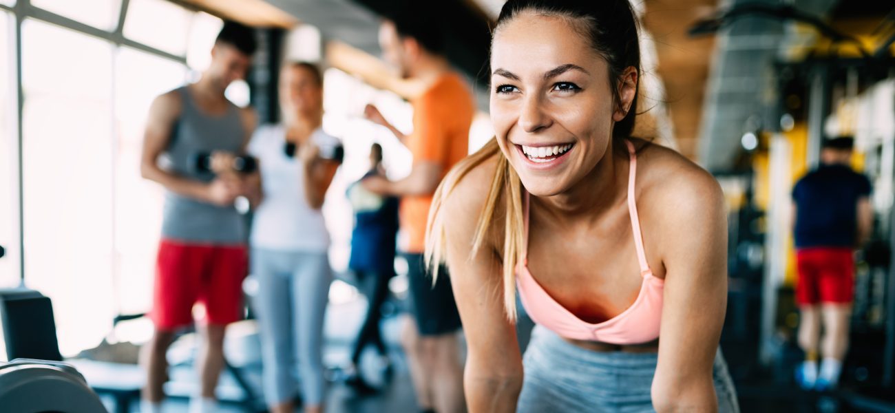 Woman in gym, happy and confident