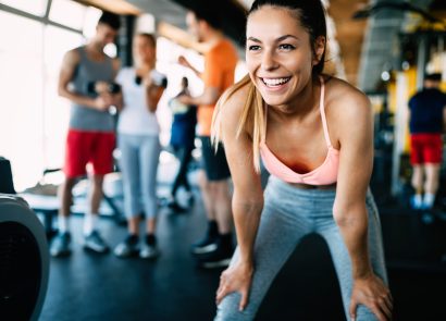 Woman in gym, happy and confident