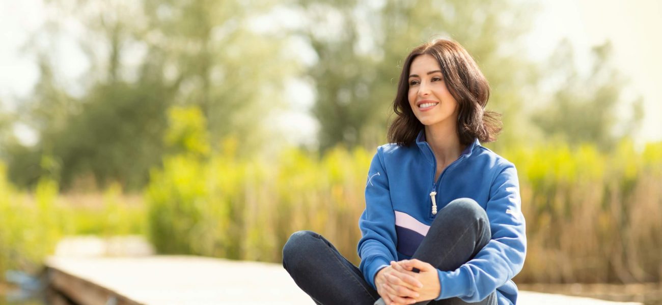 A woman sitting on a jetty