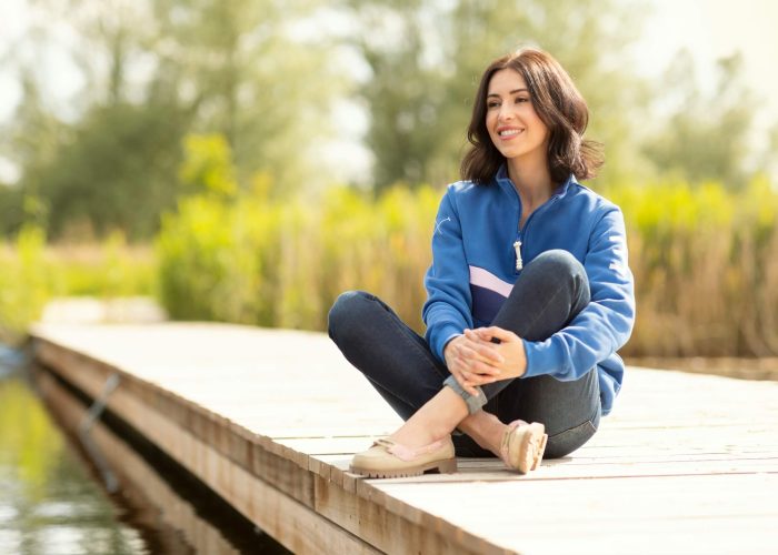 A woman sitting on a jetty