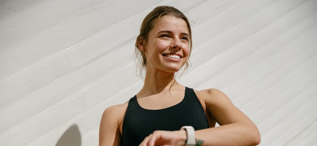 A woman exercising wearing a fitness tracker