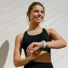 A woman exercising wearing a fitness tracker