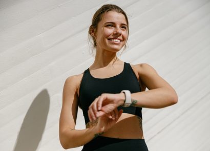 A woman exercising wearing a fitness tracker