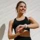 A woman exercising wearing a fitness tracker