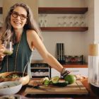 A smiling woman standing in a kitchen