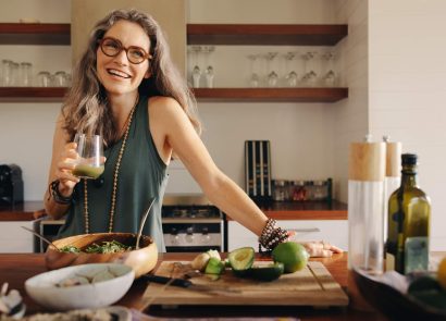 A smiling woman standing in a kitchen